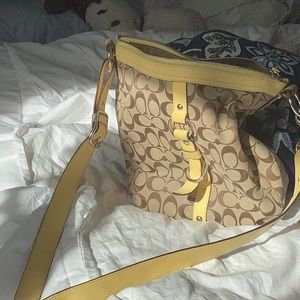 Coach shoulder bag, yellow leather strap, traditional khaki/brown logo fabric.